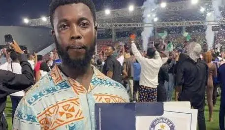 Babajide Isreal Adebanjo Strikes A Pose With His Guiness World Records Certificate 1